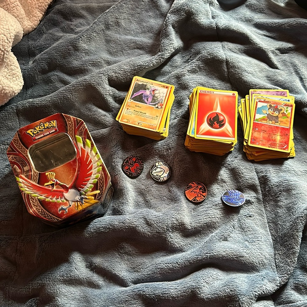 tin of pokemon cards w/ 4 coins